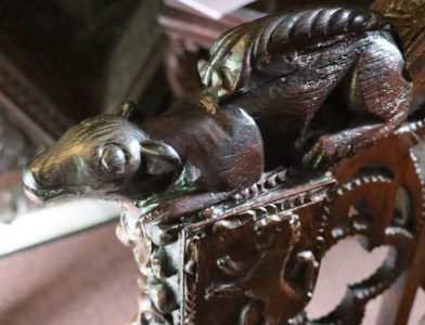 The squirrel carving at the base of the bannister