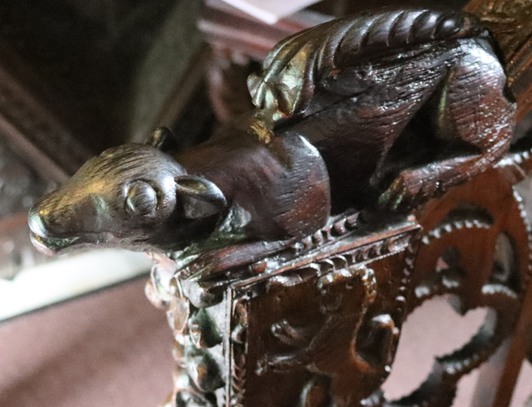 The squirrel carving at the base of the bannister